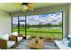 Relaxing screened patio with comfortable seating and a serene view of the lake at 11327 Burgundy Dr, Venice, FL 34293