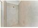 This tiled walk-in shower features neutral colored tiles and a shower head at 11327 Burgundy Dr, Venice, FL 34293