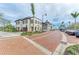 Charming street view showcasing local businesses, palm trees, and a beautiful brick-paved road with ample parking at 11327 Burgundy Dr, Venice, FL 34293