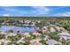 Panoramic aerial view showcasing a beautiful home with a swimming pool nestled among lush greenery and a serene lake at 11328 Rivers Bluff Cir, Lakewood Ranch, FL 34202