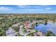 Beautiful aerial view of home with landscaping and pool near pond at 11328 Rivers Bluff Cir, Lakewood Ranch, FL 34202