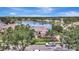 Aerial view of a lakeside home surrounded by lush landscaping and serene waters, offering a tranquil retreat at 11328 Rivers Bluff Cir, Lakewood Ranch, FL 34202
