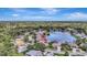 Beautiful aerial view of home with landscaping and pool near pond at 11328 Rivers Bluff Cir, Lakewood Ranch, FL 34202