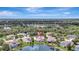 Beautiful aerial view of home with landscaping and a screened pool near a pond at 11328 Rivers Bluff Cir, Lakewood Ranch, FL 34202