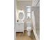 Bright bathroom with a round mirror and open shower at 11328 Rivers Bluff Cir, Lakewood Ranch, FL 34202