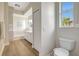 A stylish bathroom with a tiled shower/tub, bright window, and modern vanity for added convenience at 11328 Rivers Bluff Cir, Lakewood Ranch, FL 34202