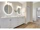 A bright bathroom showcasing double sinks, modern lighting, and sleek fixtures for a luxurious feel at 11328 Rivers Bluff Cir, Lakewood Ranch, FL 34202