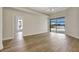 Bright bedroom featuring wood floors and sliding glass doors leading to the lanai at 11328 Rivers Bluff Cir, Lakewood Ranch, FL 34202