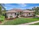 Well-manicured lawn and landscaped gardens add charm to this inviting single-story home at 11328 Rivers Bluff Cir, Lakewood Ranch, FL 34202