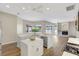 Modern kitchen featuring a center island with quartz countertop and sink, modern appliances and sleek cabinets at 11328 Rivers Bluff Cir, Lakewood Ranch, FL 34202