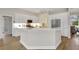 Bright kitchen with white cabinets, quartz countertops, modern appliances and an island with bar seating at 11328 Rivers Bluff Cir, Lakewood Ranch, FL 34202