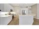 Bright kitchen with modern appliances, white cabinets, quartz countertops and an island with bar seating at 11328 Rivers Bluff Cir, Lakewood Ranch, FL 34202