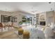 Bright open plan living room with lake and pool views, a fireplace, and hardwood floors at 11328 Rivers Bluff Cir, Lakewood Ranch, FL 34202