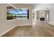 Bright living room with fireplace, hardwood floors and a view of the lake from a large window at 11328 Rivers Bluff Cir, Lakewood Ranch, FL 34202