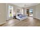 Brightly lit main bedroom featuring hardwood floors and access to the outdoor patio at 11328 Rivers Bluff Cir, Lakewood Ranch, FL 34202