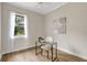 Bright home office features a ceiling fan, a modern desk, a chair, and a large window with a pleasant view at 11328 Rivers Bluff Cir, Lakewood Ranch, FL 34202