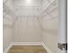 A walk-in closet with neutral walls, light wood flooring, and wire shelving for optimal storage at 11328 Rivers Bluff Cir, Lakewood Ranch, FL 34202