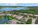 Stunning aerial view showcases luxurious homes with pools and lush landscaping near a tranquil lake and verdant trees at 11508 30Th E Cv, Parrish, FL 34219