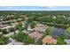 Bird's eye view of homes encircling a lake, surrounded by a vibrant green landscape, in a residential neighborhood at 11508 30Th E Cv, Parrish, FL 34219
