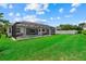Expansive backyard featuring a screened-in pool and spa, accompanied by a well-maintained lawn at 11508 30Th E Cv, Parrish, FL 34219