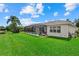 Spacious backyard with a screened-in pool and spa, lush green lawn and exterior view of the single Gathering home at 11508 30Th E Cv, Parrish, FL 34219