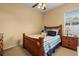 Bedroom featuring a ceiling fan and a wood bed with blue accents at 11508 30Th E Cv, Parrish, FL 34219