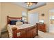 Bright bedroom featuring a wooden bed frame, ceiling fan, and an entertainment center with TV at 11508 30Th E Cv, Parrish, FL 34219
