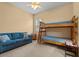Bedroom featuring bunk beds, a window and a blue couch at 11508 30Th E Cv, Parrish, FL 34219