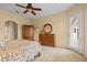 Bedroom featuring an area rug, wooden dresser, and access to outdoor patio at 11508 30Th E Cv, Parrish, FL 34219