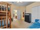 Bedroom featuring bunk beds, a black dresser, an adjoining bathroom and kitchen at 11508 30Th E Cv, Parrish, FL 34219