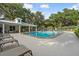 Community pool area with lounge chairs and tables surrounded by lush trees at 11508 30Th E Cv, Parrish, FL 34219