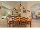 Dining room table in front of a large window with access to the pool area and living area at 11508 30Th E Cv, Parrish, FL 34219