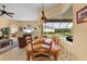 Dining room area with large table, tile floors, and a beautiful view of the pool at 11508 30Th E Cv, Parrish, FL 34219