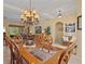 Bright dining room with a chandelier and a wooden table at 11508 30Th E Cv, Parrish, FL 34219