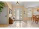 Bright foyer with tile floors and an elegant white front door with decorative glass and sidelights at 11508 30Th E Cv, Parrish, FL 34219