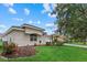 Beautifully landscaped front yard of a single Gathering home with flowering plants and a view of the neighborhood at 11508 30Th E Cv, Parrish, FL 34219