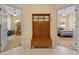 Open hallway featuring access to two bedrooms and a wooden hall tree with bench at 11508 30Th E Cv, Parrish, FL 34219