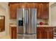 Stainless steel refrigerator with wooden cabinets and countertops at 11508 30Th E Cv, Parrish, FL 34219