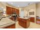 Kitchen featuring wooden cabinets, island, and stainless appliances at 11508 30Th E Cv, Parrish, FL 34219