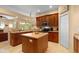 Open kitchen with a kitchen island and wooden cabinets at 11508 30Th E Cv, Parrish, FL 34219