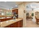 Open kitchen features wooden cabinetry, countertops, and views to the living room and outside at 11508 30Th E Cv, Parrish, FL 34219
