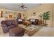 Spacious living room with a kitchen view, leather couches, rug, and decorative accents at 11508 30Th E Cv, Parrish, FL 34219
