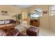 Bright living room boasts tile floors, comfortable seating, and a beautiful view of the outdoors at 11508 30Th E Cv, Parrish, FL 34219