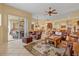Large living room features tile floors, arched doorway, open floorplan and access to the patio at 11508 30Th E Cv, Parrish, FL 34219