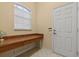 Office area featuring a desk, a window and a white door at 11508 30Th E Cv, Parrish, FL 34219