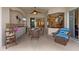 Outdoor kitchen and dining area with wicker furniture and an additional sitting area at 11508 30Th E Cv, Parrish, FL 34219