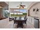 Spacious covered patio with ample seating, an outdoor kitchen and a view of the pool at 11508 30Th E Cv, Parrish, FL 34219