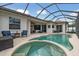 Beautifully screened pool and hot tub with patio chairs and tables surrounding at 11508 30Th E Cv, Parrish, FL 34219