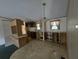A kitchen area featuring a window over the sink and wood cabinetry at 13023 Taylor St, Brooksville, FL 34613