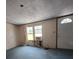 Living room featuring large windows and a front door entrance at 13023 Taylor St, Brooksville, FL 34613